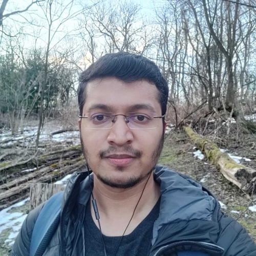 Student Gautam Gare standing in a wooded area