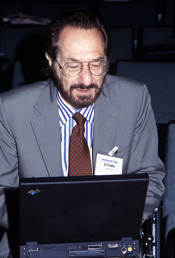 Portrait of Ed Fredkin using a laptop.