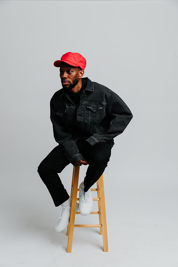 Ian Clark sits on a stool