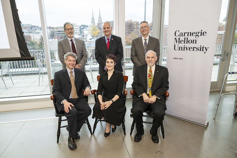 Posed photo of Alex John London, Hoda Heidari and Brad Myers seated with the deans of Dietrich College and MCS and the provost standing behind them.