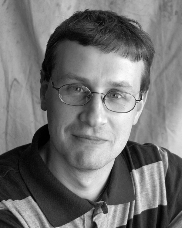 A black and white headshot of Maxim Likhachev.