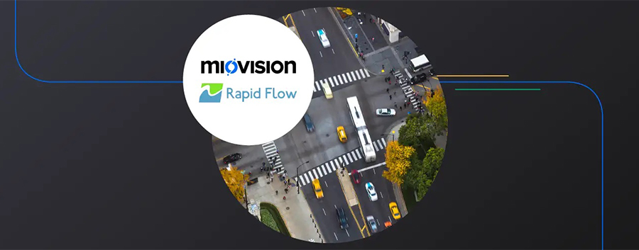 The Rapid Flow logo superimposed on a aerial view of a busy urban intersection.