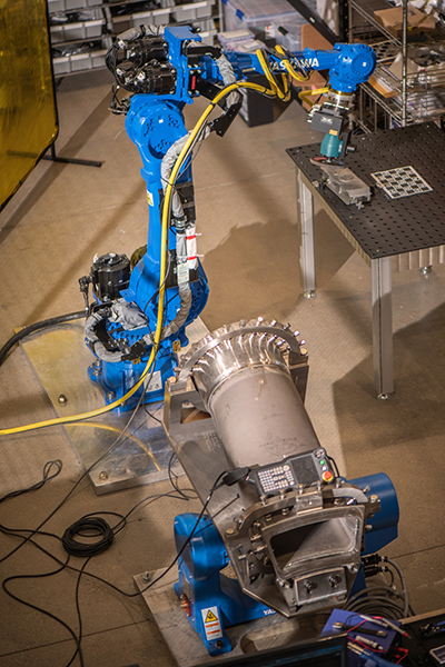  A blue robotic arm in an industrial environment.