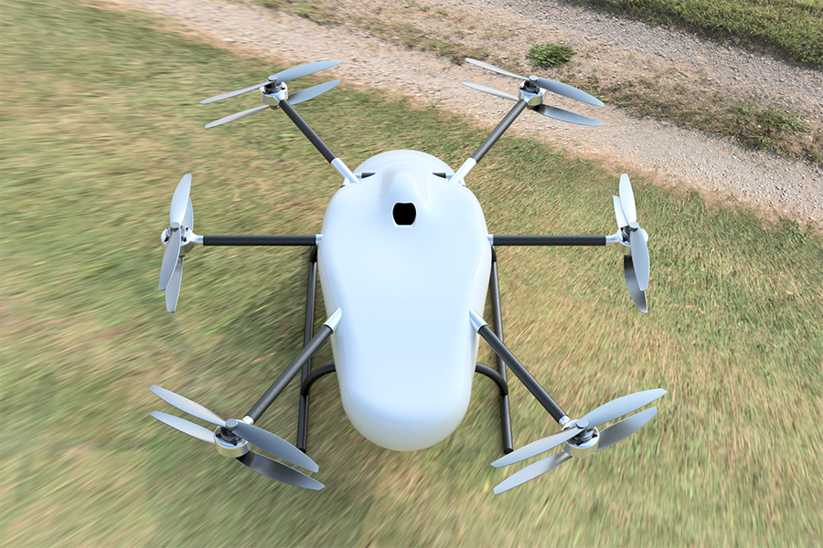  A large white drone sits on grass near a dirt road.