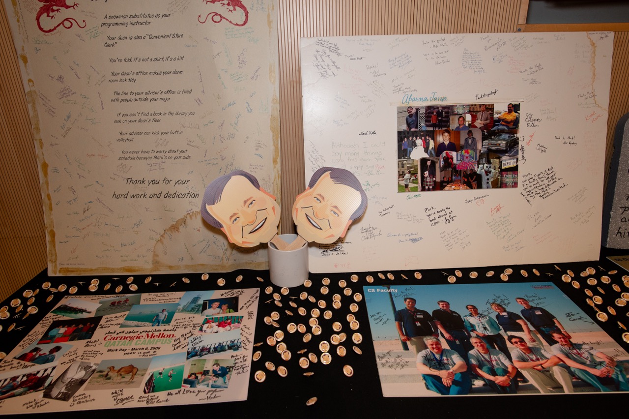 Table arranged with posters and cartoon masks and pins of the party's guest of honor