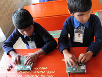 Visually impaired teacher learns how to use the Braille Writing Tutor.